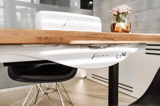 Aspirateur intégré Afinia NDC 1000 sous table avec grille décorative et design élégant.